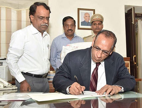 Governor ESL Narasimhan signs the file approving the Cabinet’s decision on Assembly dissolution, here on Thursday | EXPRESS