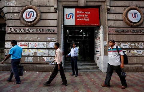 People walk past the Union Bank of India branch in Kolkata. (Photo | Reuters)