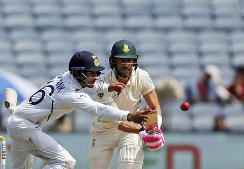 South African cricketer Faf du Plessis bats as Mayank Agarwal dives to stop the ball. (Photo | AP)