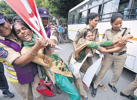 Police grab students who attempted to lay seige to Bus Bhavan as part of the RTC employees’ strike, in Hyderabad.