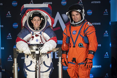 The two NASA spacesuit ​prototypes for lunar exploration, one for launch and re-entry aboard the agency's Orion spacecraft, known as the Orion Crew Survival Suit, is worn by Dustin Gohmert (R) and one for exploring the surface of the Moon's South Pole, kn