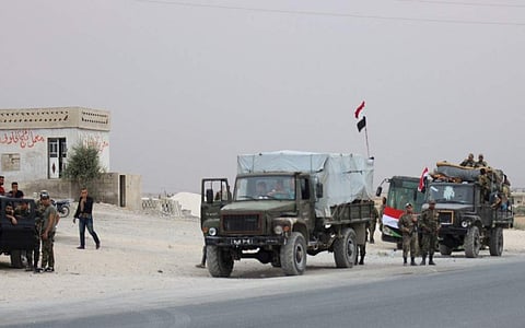 A convoy of military vehicles and busses transporting Syrian regime troops are stationed on the outskirts of the northern Syrian border town of Kobane (also known as Ain Arab) on October 16, 2019 (Photo| AFP)