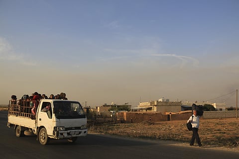 Syrians flee shelling by Turkish forces .  (Photo | AP)