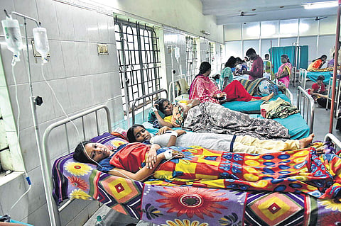 A scene from Avadi taluk hospital where one bed is being shared by two fever patients | P Jawahar