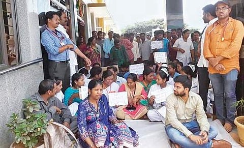 Doctors and staff stage a protest against manhandling of a doctor in Vizag  Agency on Tuesday | express