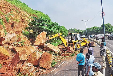 Boulders Kailasagiri which fell on Vizag  Bheemili beach road near Tenneti park being cleared  using earthmovers in Visakhapatnam | G Satyanarayana