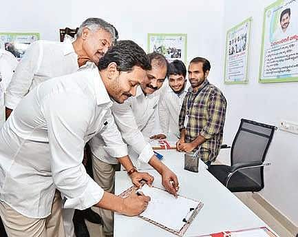 Jagan signs in the visitor’s book during inauguration of Village Secretariat system at Karapa in East Godavari district. (Photo | EPS)