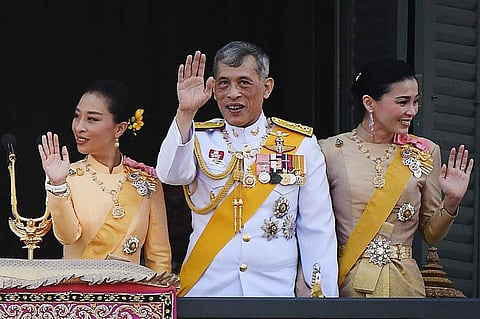Thailand's King Maha Vajiralongkorn (C), Queen Suthida (R) nd his daughter Princess Bajrakitiyabha Mahidol (L) wave to well-wishers from the balcony of Suddhaisavarya Prasad Hall of the Grand Palace. (Photo | AFP)