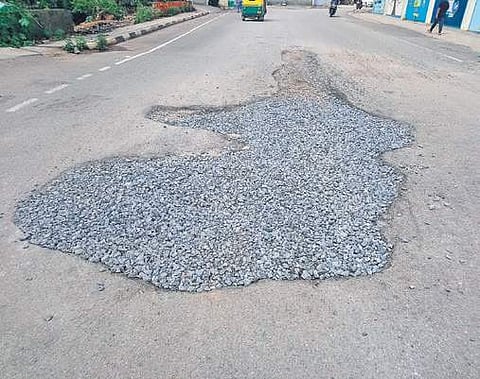 A pothole fixed with only jelly stones. Many two-wheeler riders have skid here because of the unscientific work