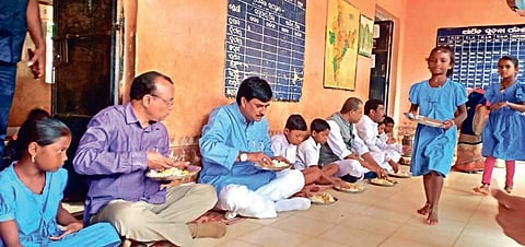 School and Mass Education Minister Samir Ranjan Dash having mid-day meal with students of Upper Primary School in Pujariput village on Tuesday I Express