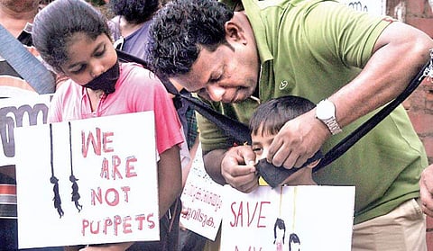 Rizvin and Ritha, siblings from Elamakkara, in the forefront of a protest seeking justice for Walayar sisters at Vanchi Square in Kochi on Tuesday. The children arrived with self- painted placards to register their protest on the issue| A Sanesh