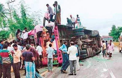 People crowd the accident site where the bus overturned, in Tumakuru, Karnataka, on Wednesday | Express