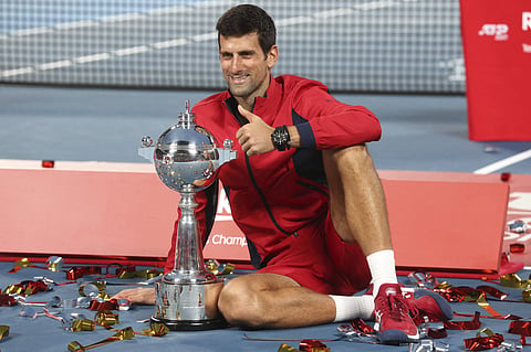 Novak Djokovic of Serbia poses with his champion trophy during the award ceremony of the Japan Open. (Photo | AP)