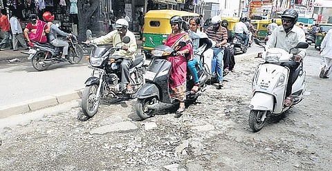 Potholes like this one on BVK Iyengar Road are a common feature on most roads in the city | express