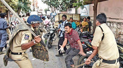 Policemen resort to lathi charge after TSRTC employees, among thousands of protesters, tore down barricades at Tank Bund in Hyderabad. (Photo | EPS, Vinay Madapu)