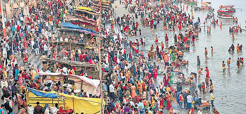 Hindu devotees gather at a ghat in Ayodhya on Tuesday to take a dip in the Saryu River on the occasion of Kartik Purnima. The throng was officially pegged at 3 lakh. (Photo | PTI)