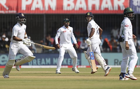 Bangladesh players react as India's Mayank Agarwal, second right, and batting partner Ajinkya Rahane, left, run between the wickets to score during the second day of first cricket test match between India and Bangladesh in Indore, India, Friday, Nov. 15, 