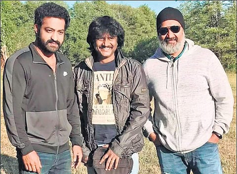 Jr NTR, a crew member  and SS Rajamouli on the sets of RRR