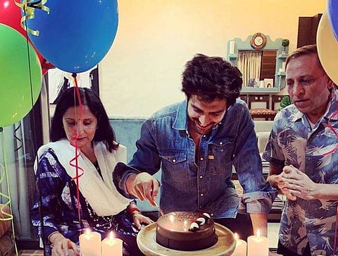 Kartik Aaryan cuts his birthday cake with his parents by his side. (Photo | Instagram)