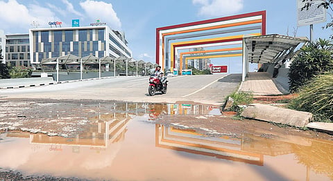 Pothole-filled roads to Infopark are creating difficulties for techies.  Waterlogging in front of the Smart City entrance (Photo | Arun Angela, EPS)