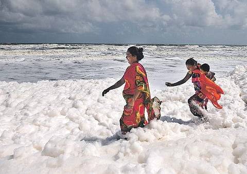 Not aware of the potential harm, visitors at Pattanipakkam beach enjoying themselves amidst a thick blanket of froth on Friday  | DEBADATTA MALLICK