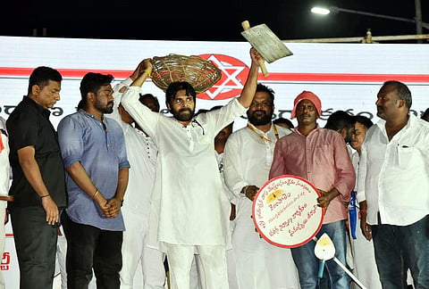 Jana Sena chief Pawan Kalyan with a shovel and a basket at a public meeting after  his  long march over sand scarcity, in Visakhapatnam on Sunday. (Photo | EPS/G satyanarayana)