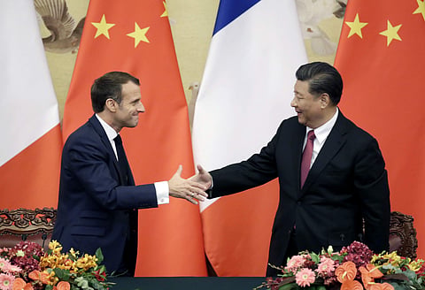 French President Emmanuel Macron, left, shakes hands with China's President Xi Jinping after a joint news conference at the Great Hall of the People in Beijing, China. (Photo | AP)