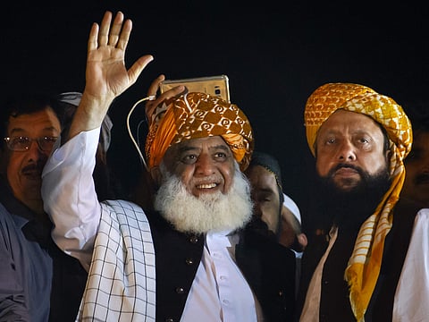 Firebrand cleric Maulana Fazlur Rehman waves to his supporters during an anti-government march in Islamabad, Pakistan. (Photo | AP)