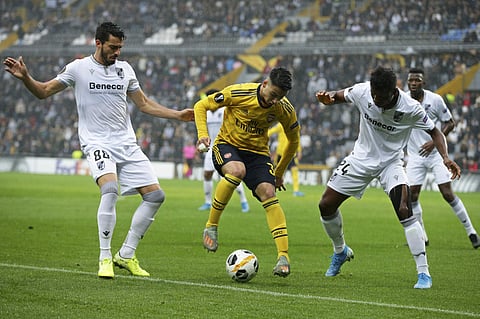 Arsenal's Gabriel Martinelli controls the ball between Vitoria's Mikel Agu and Pepe, left. (Photo | AP)