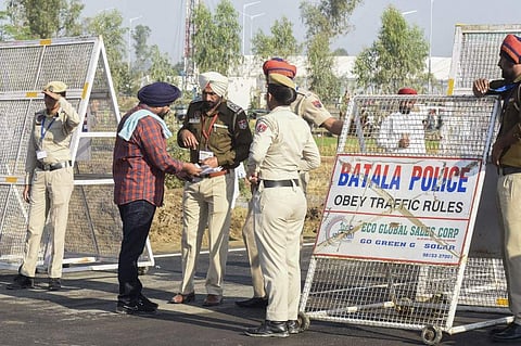 A Sikh pilgrim shows his documents to police before crossing over to Pakistan for the inauguration ceremony of the Kartarpur Corridor in Dera Baba Nanak on November 9, 2019, as Indian Sikh pilgrims visited the shrine of Baba Guru Nanak Dev at the Gurdwara