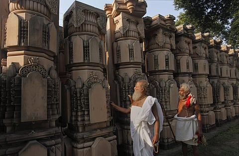 Hindu men look at pillars lying at a workshop for the construction of a Rama temple in Ayodhya (File Photo| AP)