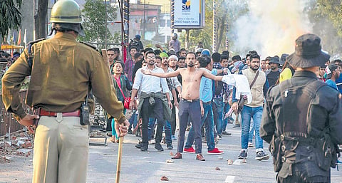 Protesters clash with the police during their march against the Citizenship Amendment Bill in Guwahati on Thursday. (Photo | PTI)