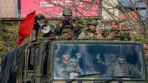 Army jawans conduct a flag-march in a locality during relaxation of curfew in Dibrugarh on Friday (Photo | PTI)