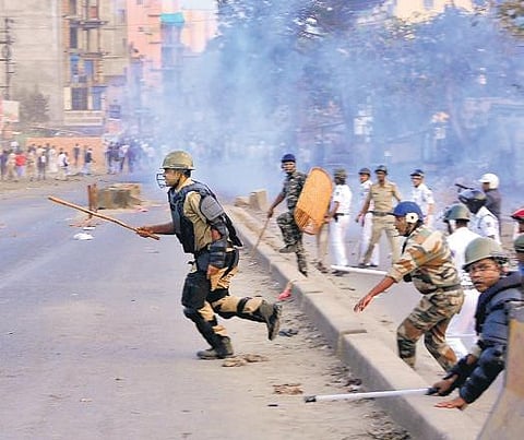 Police chase away agitators who were protesting against NRC and Citizenship Amendment Act, at Bankra in Bengal’s Howrah district on Monday. | (Photo | PTI)