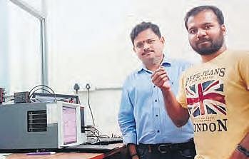 Suryanarayana Jammalamadaka and Dwipak Prasad Sahu showing the sensor to detect BSA