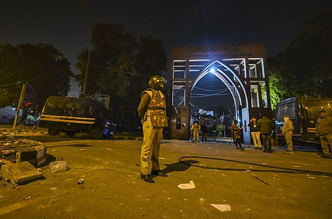 A policeman stands guard outside Jamia Millia Islamia University. (Photo | PTI)