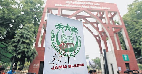 Jamia Millia Islamia students raise banners to protest the Citizenship Amendment Act (CAA) and Sunday’s police crackdown in the university campus, in New Delhi on Monday. (Photo | Shekhar Yadav)