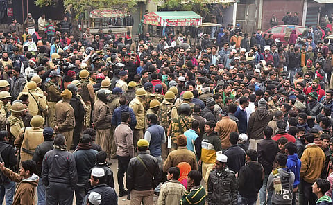 Police keep vigil as stuents along with local residents hold a protest against NRC and Citizenship Amendment Act in Dodhpur locality of Aligarh. (Photo | PTI)