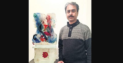Artist and flimmaker Sisir Sahana; few of his glass sculptures from the show, A Dialogue with Soil