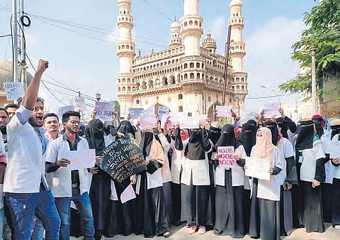 Students of Government Nizamia Tibbi College protest at Charminar. (Photo | EPS)