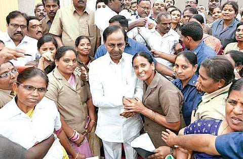 Chief Minister K Chandrasekhar Rao poses with employees of  the RTC at Pragathi Bhavan in Hyderabad on Sunday.