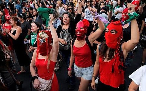 Women sing and perform during the performance of 'Un violador en tu camino' (A rapist in your way) by feminist group Lastesis on December 19, 2019 in Santiago, Chile. (Photo | AFP)