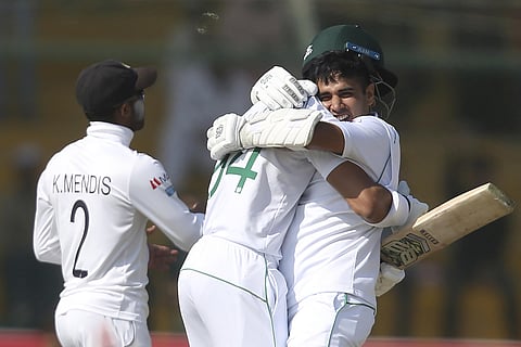 Pakistan's Abid Ali, right, celebrates his century with teammate Shan Masood against Sri Lanka. (Photo | AP)