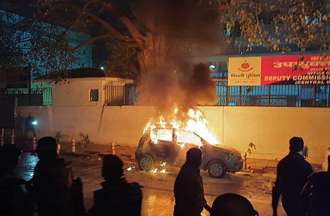 A car burns after being set on fire during demonstrations against India's new citizenship law in New Delhi on Friday.  (Photo | EPS/Shekhar Yadav)