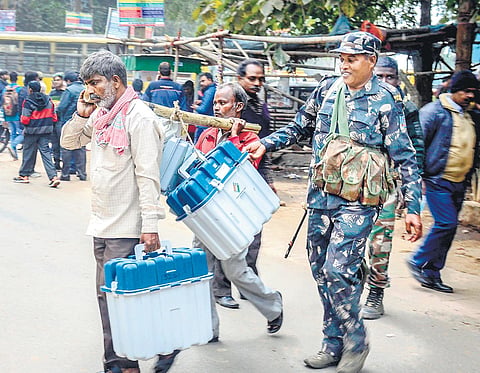 In Dhanbad, a poll staff carries EVM machines and other polling materials for of Jharkhand elections. (File PTI Photo)