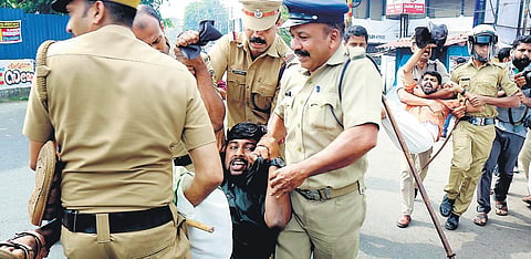 Police removing SFI workers who waved black flags at Minister of State for External Affairs V Muraleedharan at the Town Hall in Kozhikode on Tuesday | Express