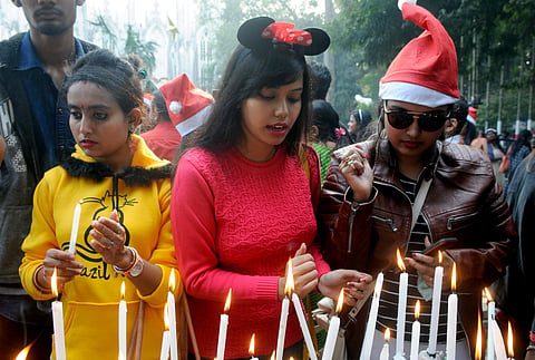 Devotees light candles at St. Paul's cathedral church on the occasion of Christmas Celebrations, in Kolkata. (Photo| ANI)