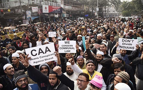 Demonstrators hold placards and raise slogans during a protest against the Citizenship Amendment Act (CAA) and National Register of Citizens (NRC), at Jama Masjid in New Delhi. 