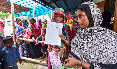 People check their names on the final draft of the state's National Register of Citizens after it was released, at a NRC Seva Kendra in Nagaon, Assam.