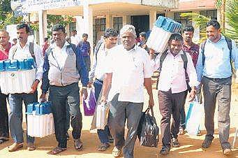 Staffers on election duty in Hunsur  on Wednesday | Express